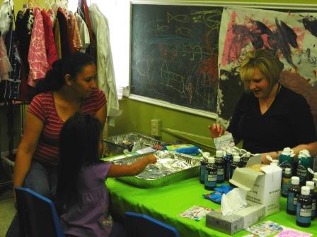 Brittany Moore volunteering at the shaving cream marbling art station