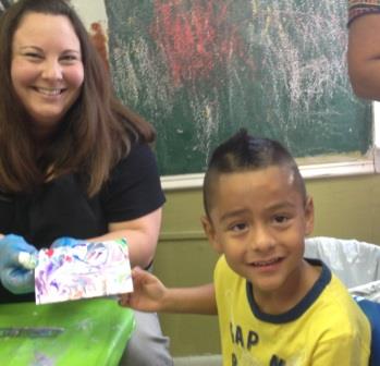 Brianne Wojtowicz showing the final art piece of the shaving cream marbling technique